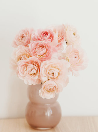 Bouquet pale pink ranunculus flowers in vase on light background. front view. Close up, copy spaceの写真素材