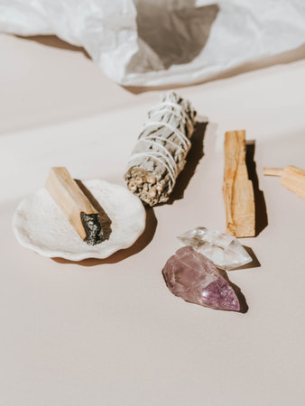 White sage and Palo Santo and amethyst and quartz crystals on a light beige background. A set of incense for fumigationの写真素材