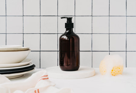 Brown bottle mockup for natural dish detergent in kitchen. Bottle with dish detergent on marble...