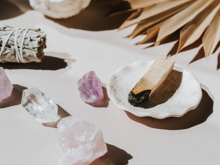 White sage and Palo Santo and amethyst and quartz crystals on a light beige background. A set of...