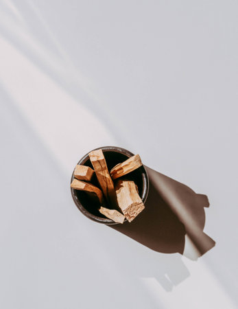 Wooden sticks Palo Santo in black box on light background. Aromatherapy and religious rites and...