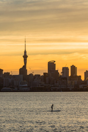Sky and Sky Tower dyed in orange by the sunset from the pier in Auckland, New Zealandの写真素材