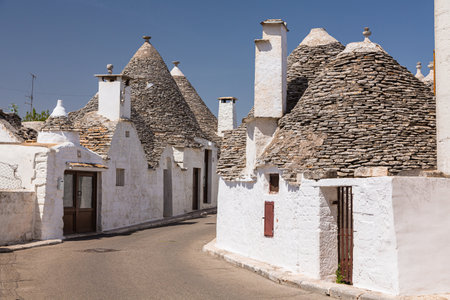 The pointed roof and white cityscape of Trulli in Alberobello, Italyの写真素材
