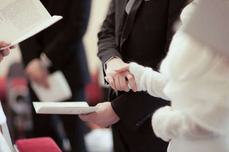 Male and female person in wedding ceremony shake hands togetherの写真素材