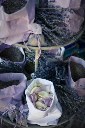 Top down view various bags with petals and tiny wild purple flowers on display in weddings decorated with ribbonsの写真素材
