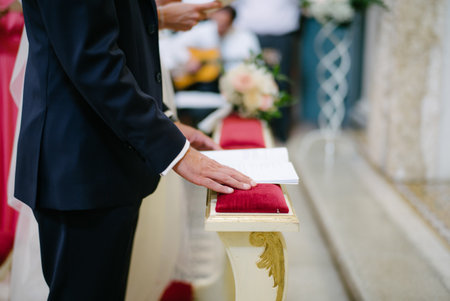 Side view groom stand and read sheet at wedding ceremonial in churchの写真素材