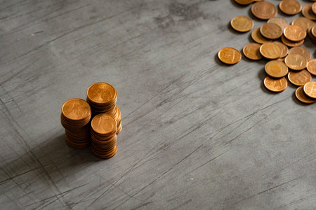 Stacks of euro cents coins on metal surface. Money saving concept