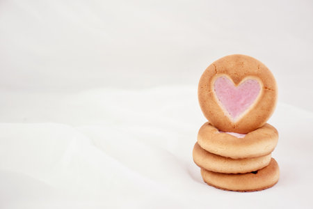 Sponge cookies with a heart and a white mug. Background for lovers on Valentine's Dayの写真素材