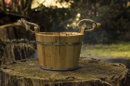 Old wood bucket on the stumpの写真素材