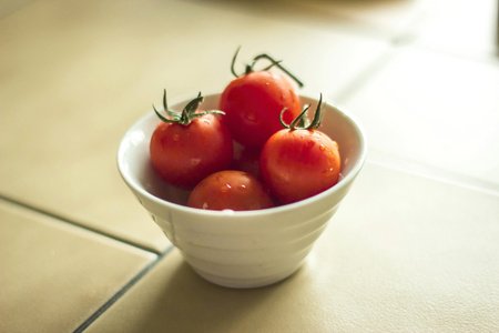 Little cherry tomatoes in white bowlの写真素材