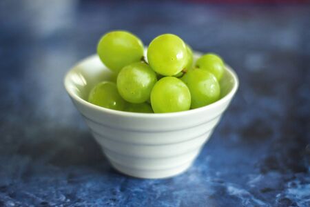 Green grapes in white bowlの写真素材