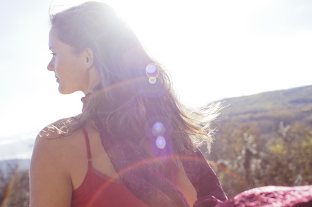 Beautiful young woman with a red dress looking in the distance の写真素材