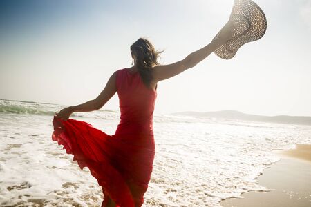 Beautiful graceful young woman enjoying the seaの写真素材