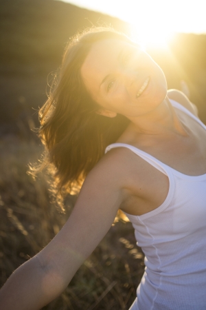 Beautiful young woman stretching her arms joyfully praising the beauty of Life.の写真素材