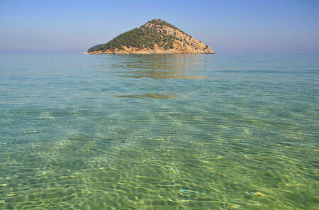 The pure waters of the Mediterranean sea at the Paradise beach on the island of Thassos, Greeceの写真素材