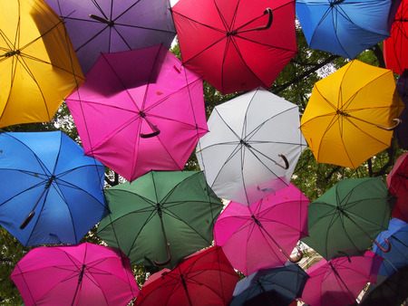Umbrellas with different colors creating a colorful backgroundの写真素材