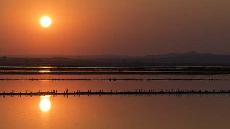 Sun setting over the salt lake near Burgas, Bulgaria.の写真素材