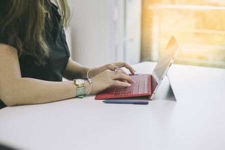 Close up of Business woman  typing text or words on tablet computer keyborad  in office