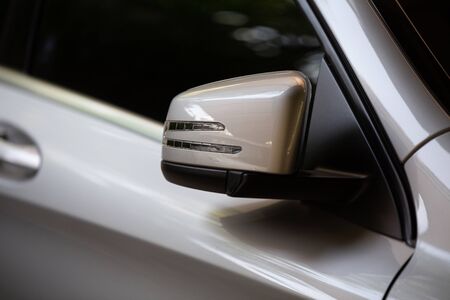 Rear-view mirror closed for safety at car park,  Rear-view mirror of gray car , black tinted glass