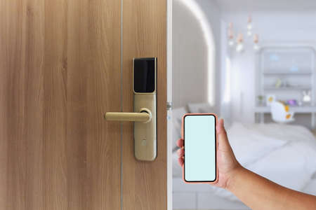 Mobile unlock Digital door lock security system of apartment door. Electronic door handle with key pads numbers. Selective focusの写真素材