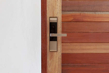 Wood door with digital door lock systems best security protection for apartment. Electronic door handle installed on wood door. Selective focusの写真素材