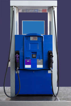 Gas station with two nozzle fuel pumps. Close-up and selective focus
