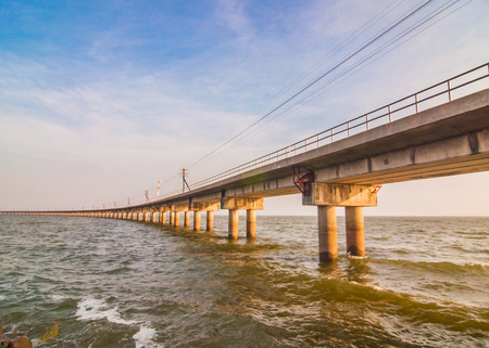 railway bridge across the dam to store waterの写真素材