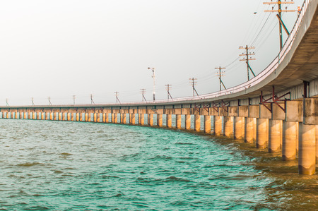railway bridge across the dam to store waterの写真素材