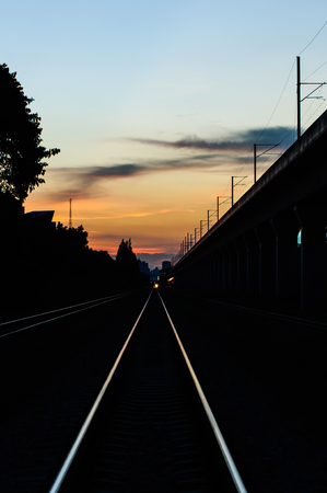 railway tracks in the shadow light of sunset.の写真素材