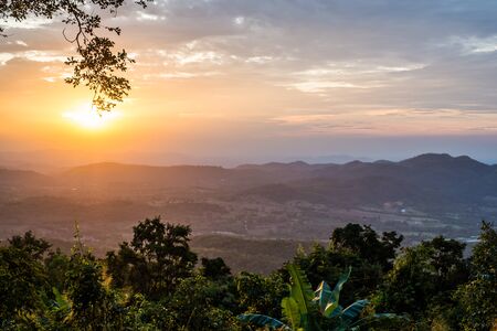 Light of sunset with mountains background in thailandの写真素材