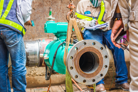Construction worker welding underground valve gas pipelineの写真素材
