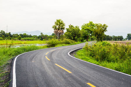 Asphalt road on countryside in thailand.の写真素材