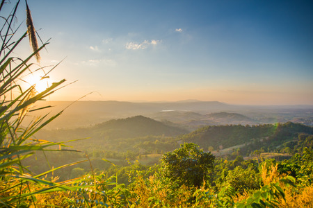 Light of sunset with mountains background in thailandの写真素材