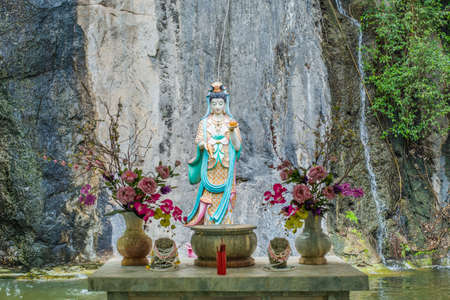 Guan Yin statue with background a mountain in Thaiand.の写真素材