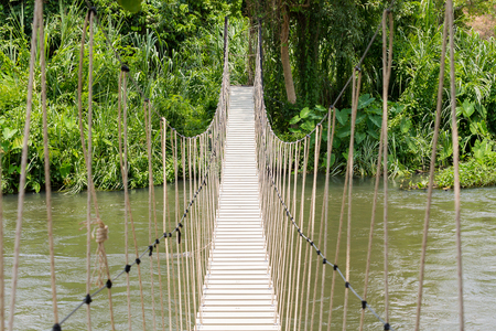 The rope bridge cross river in the jungle.の写真素材