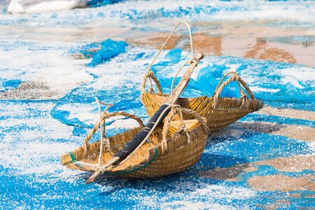 Salt farm , for produce seasoning and raw material for food products , the farmer working together to keep it into warehouse on sunny day before shipment.の写真素材