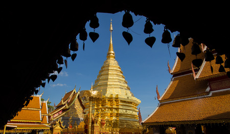 Golden Buddha's relics and pagoda on sunny and blue sky , they are in area of the public temple in Thailand.の写真素材