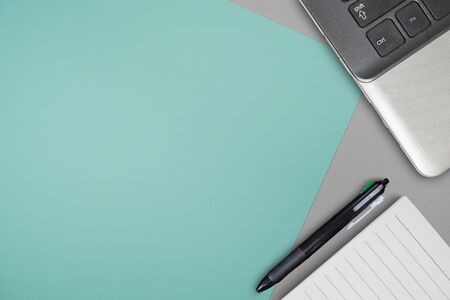 Office desk table with pen, blank paper,and notebook. Top view.