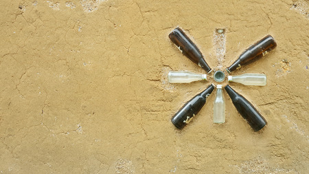 a clay wall decorated by recycled glass bottlesの写真素材