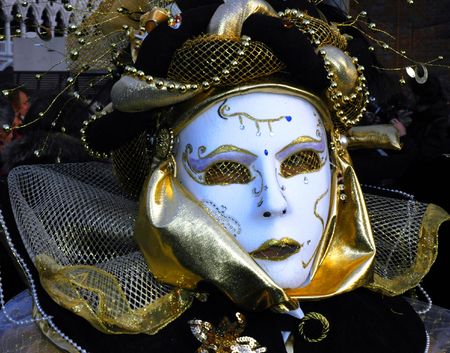 a masked woman is dressed for carnivale in venice,Italyの写真素材