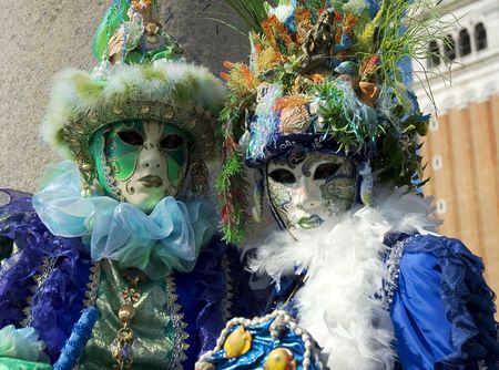 two party goers in St Marks Square,Venice,Italy dressed up in costume featuring seashells  の写真素材