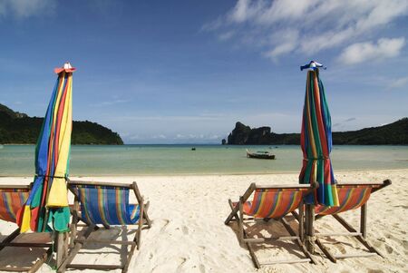 chairs and umbrellas on a tropical beach の写真素材
