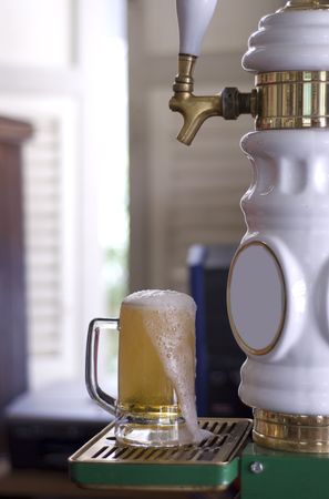 cold glass of beer with foam topの写真素材