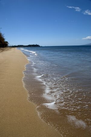 deserted beach with ocean and sand の写真素材
