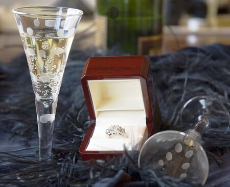 two champagne glasses and a platinum diamond ringの写真素材
