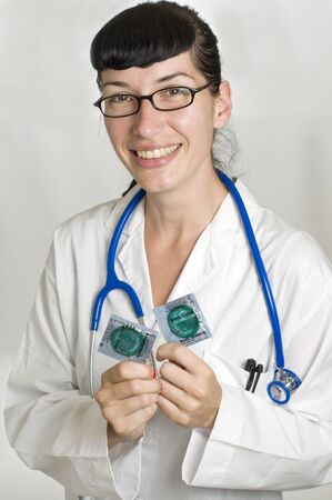 Female Doctor holding condoms for aids prvention and family planningの写真素材