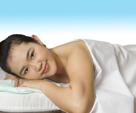 Woman laying down on massage table の写真素材