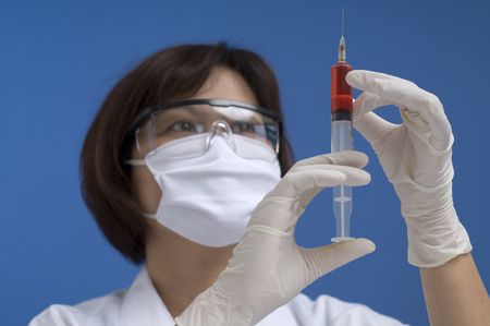 Doctor or Nurse standing with syringeの写真素材