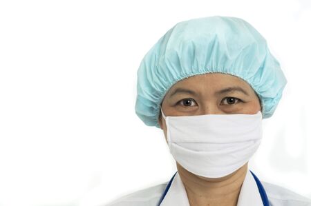 Head and shoulders portrait of Nurse with surgicial mask and hair capの写真素材