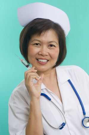 Doctor or Nurse standing with syringeの写真素材